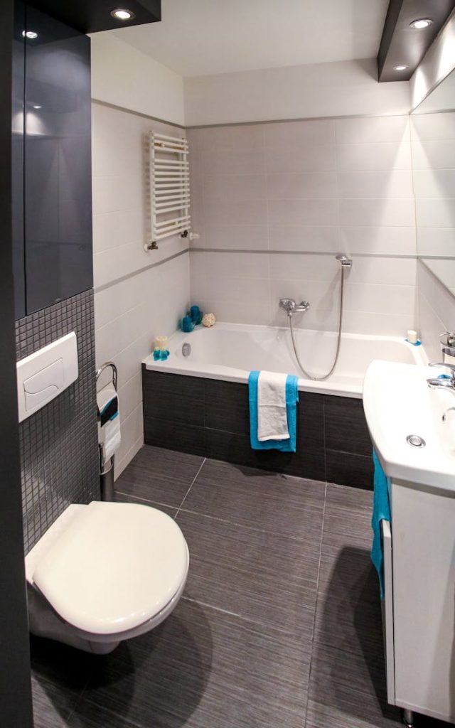 Contemporary bathroom featuring a sleek white bathtub, modern fixtures, and minimalist interior design.